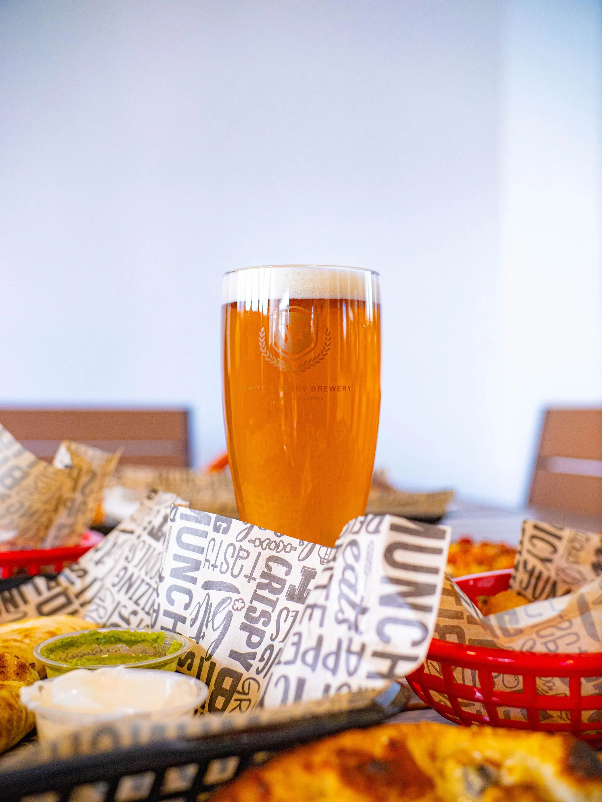 A flight of house beers beside wood-fired food at Whites Ferry